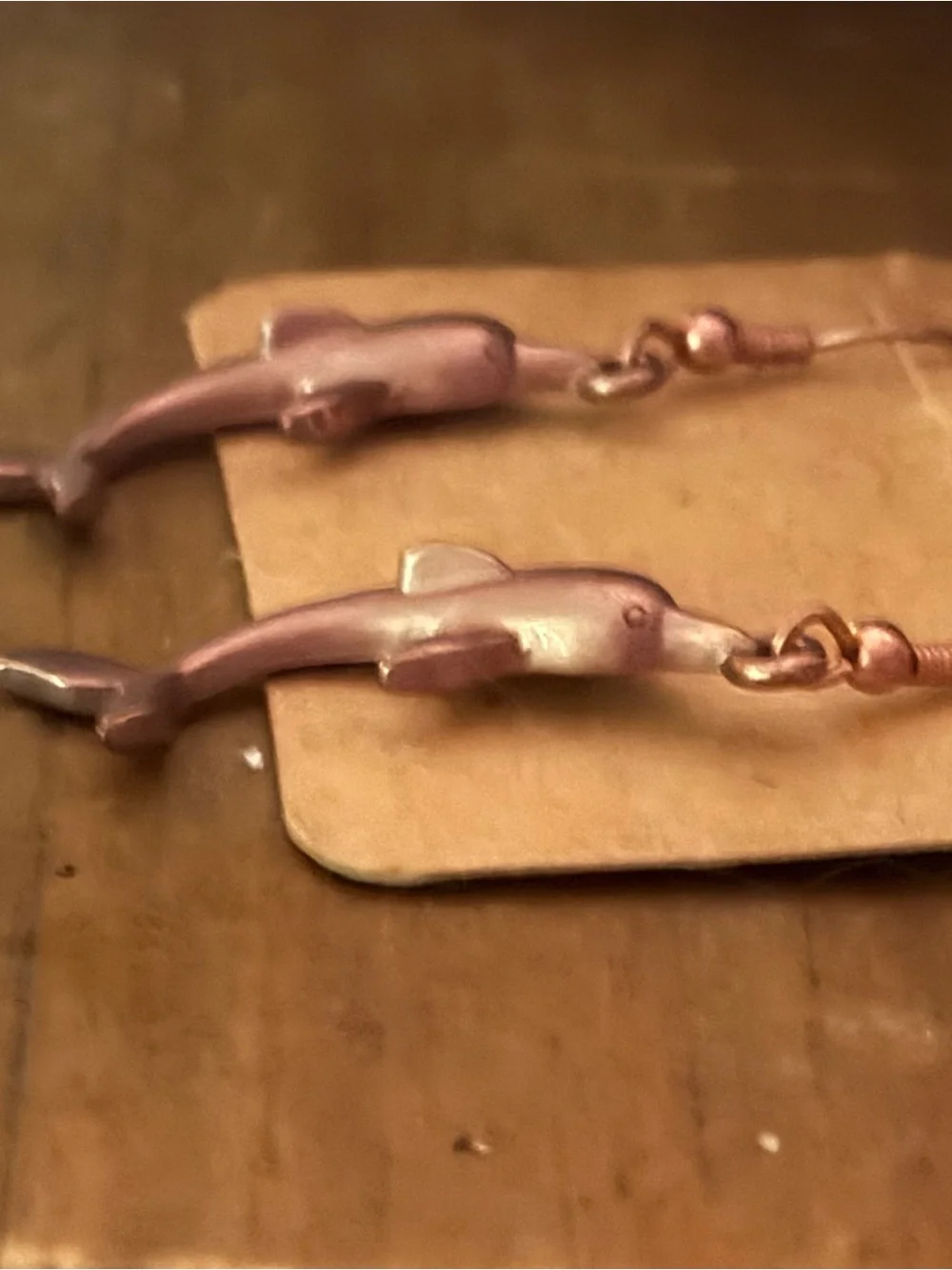 Copper tone dolphin dangle earrings